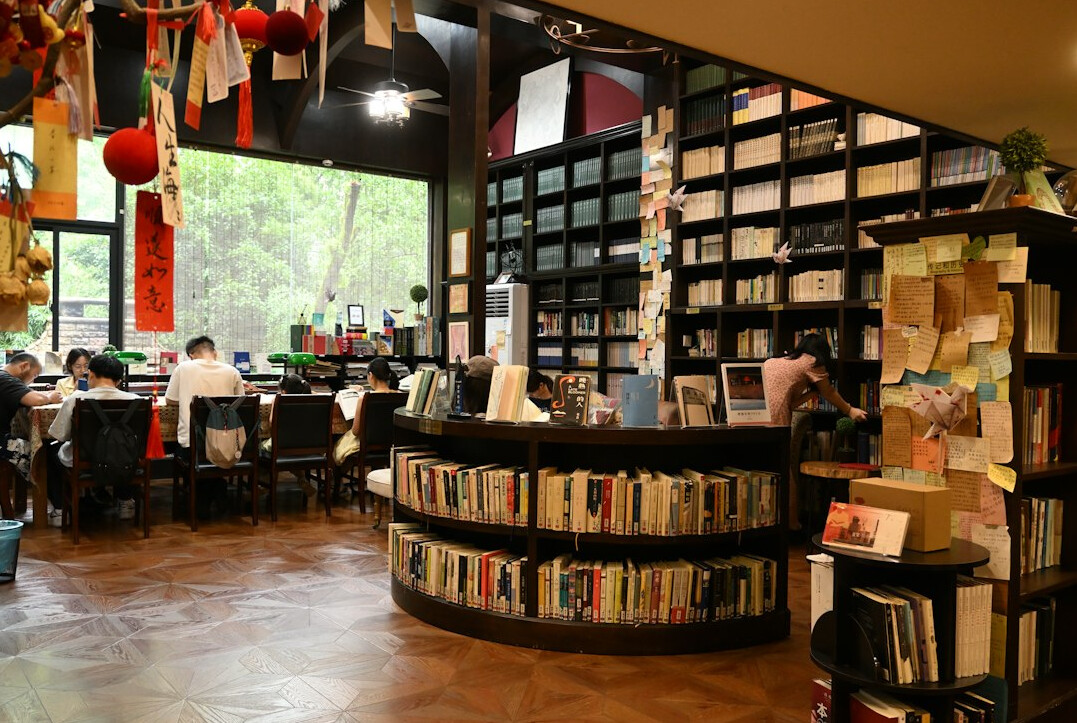Team of editors and writers working together around a table with books and papers